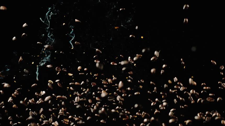 Coffee beans rain down and some are smoking