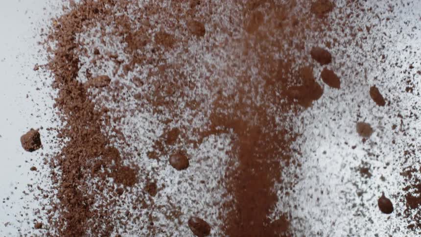 Coffee beans and grounds are shooting into the air