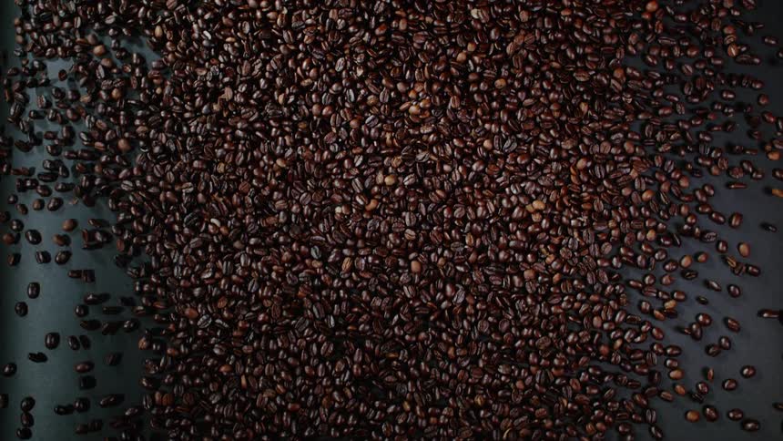 Coffee beans spill across a table