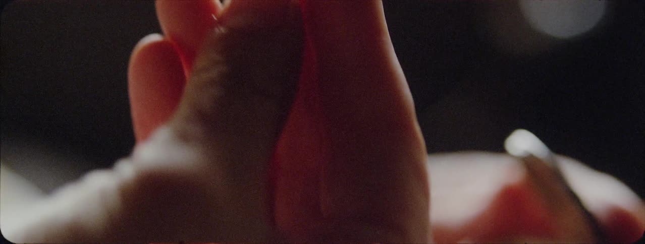 A person holds a pill in their hand