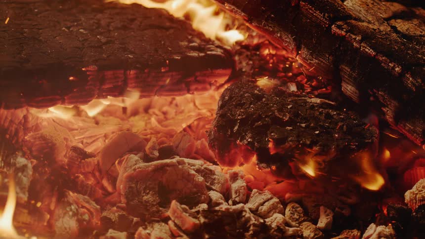 Embers glow in the wood fire