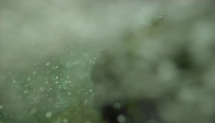 Water bubbles over a large rock