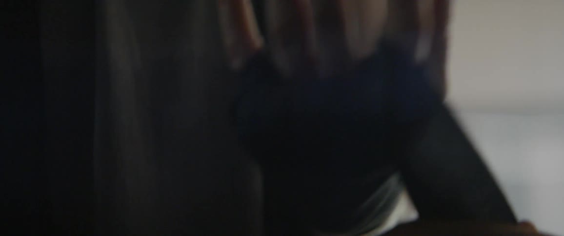 Person wraps a black bandage around their hand