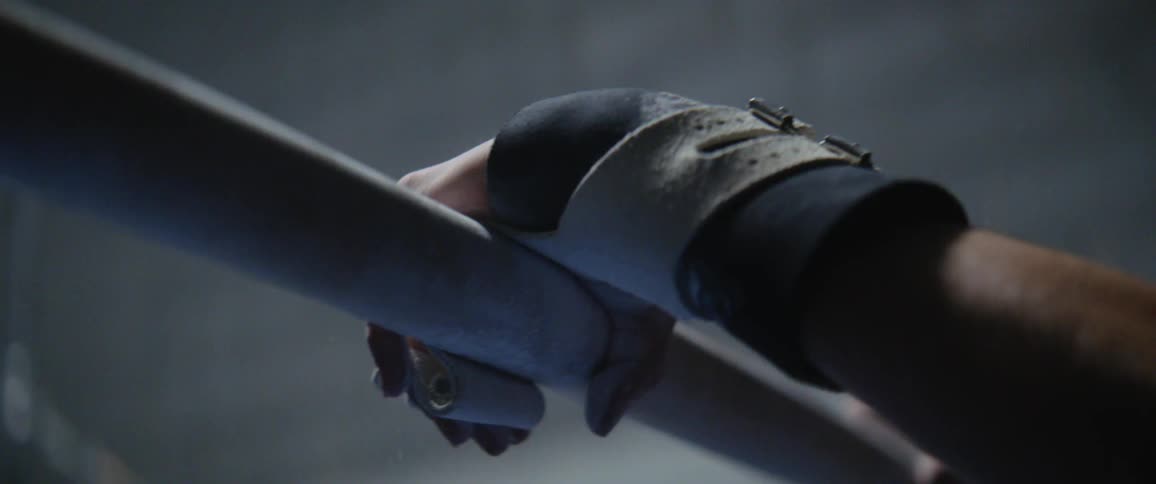 A person puts their hands on a long bar