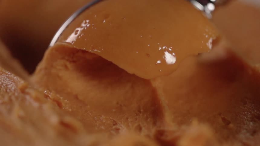 Ice cream is being scooped by an ice cream scoop