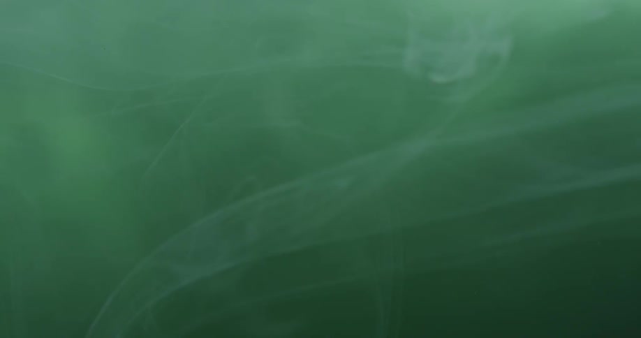 Green smoking floating around a dark area