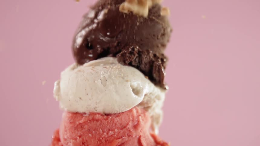 Sprinkles fall onto an ice cream cone