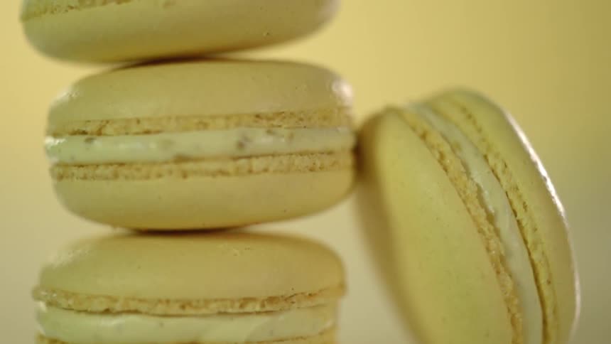 Stack of three macaroons and one leans against the stack