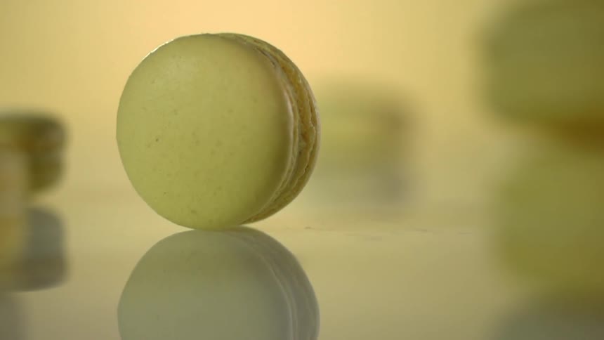 A macaroon is rolling across a surface