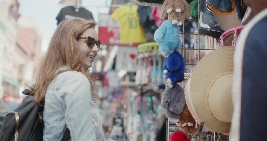 Woman looks at items in a market
