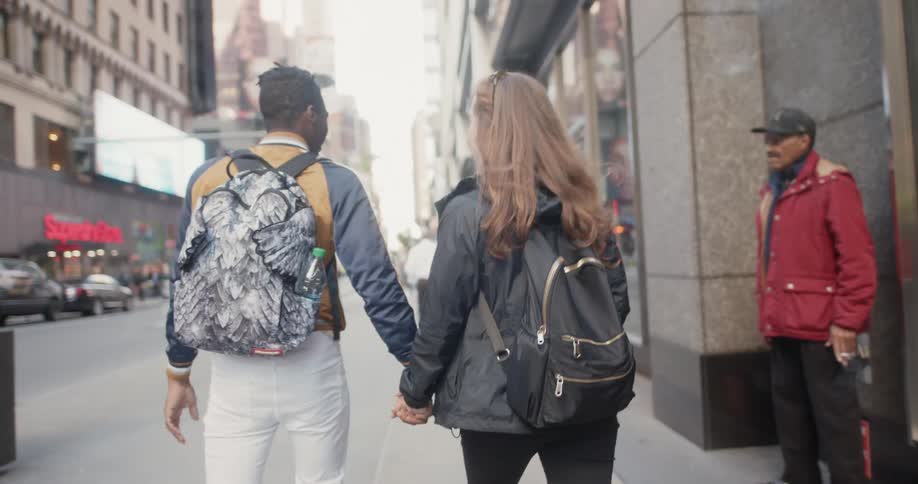 Couple walking along urban street