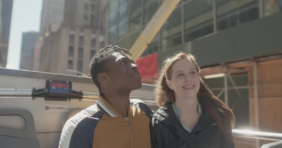 Two people take in the sites on a tour bus