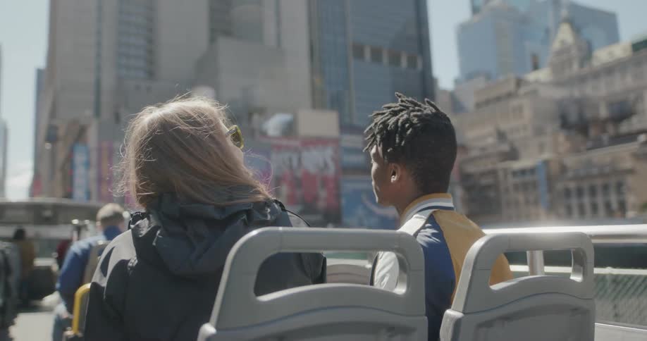 People sit on a tour bus talking