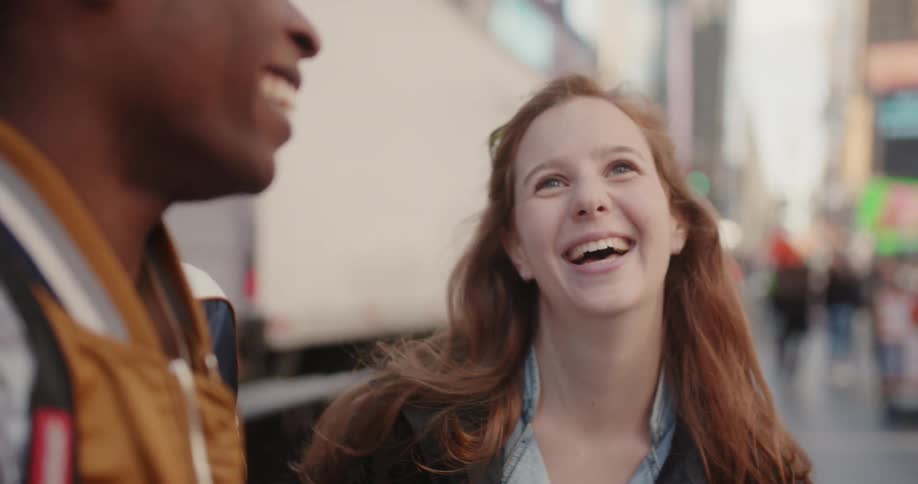 A woman talks with a man in the city