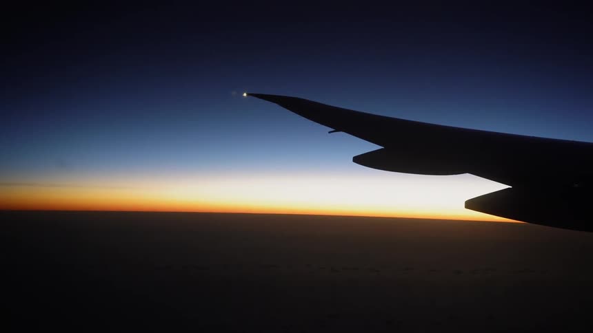 Wing of an airplane at sunset