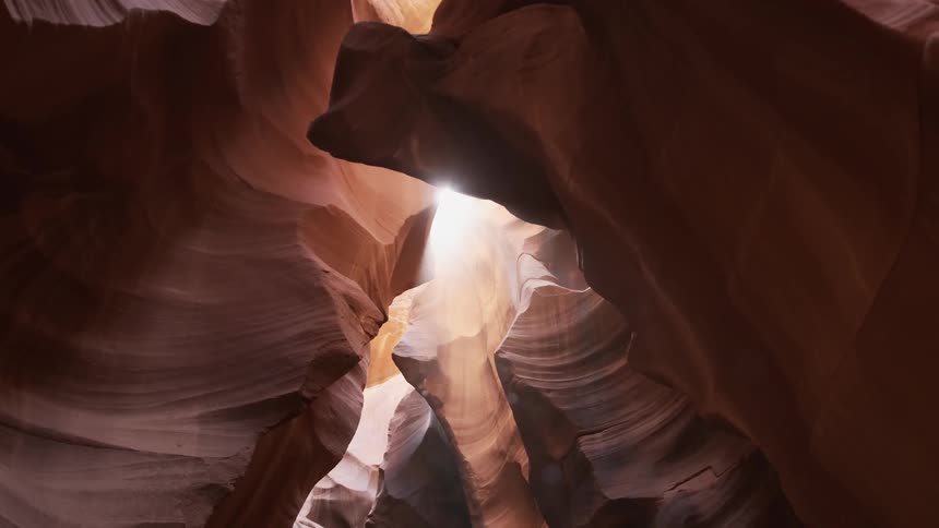 Sun shines down into a rocky cave