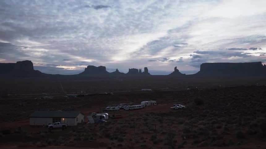 The trailers are parked before the mountain range ahead