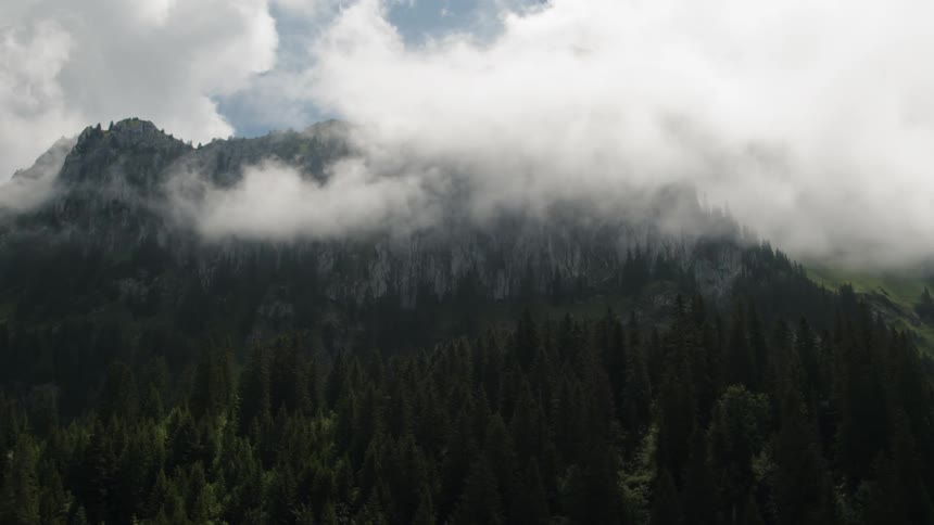 The clouds cover the top of the mountain