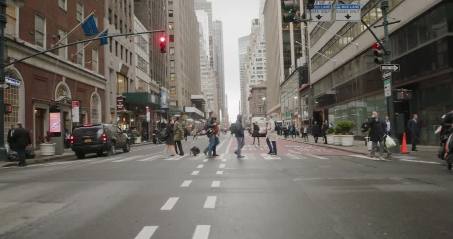 People cross a city intersection
