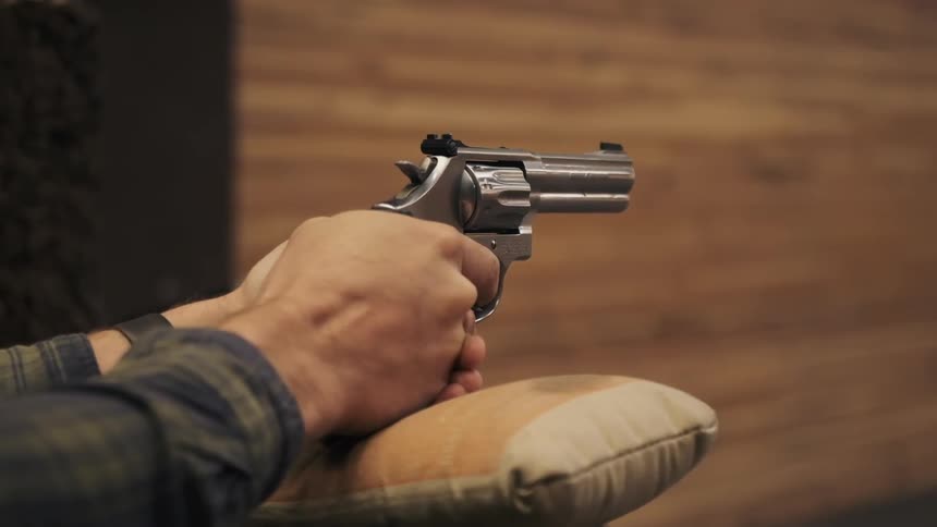Silver pistol revolver firing