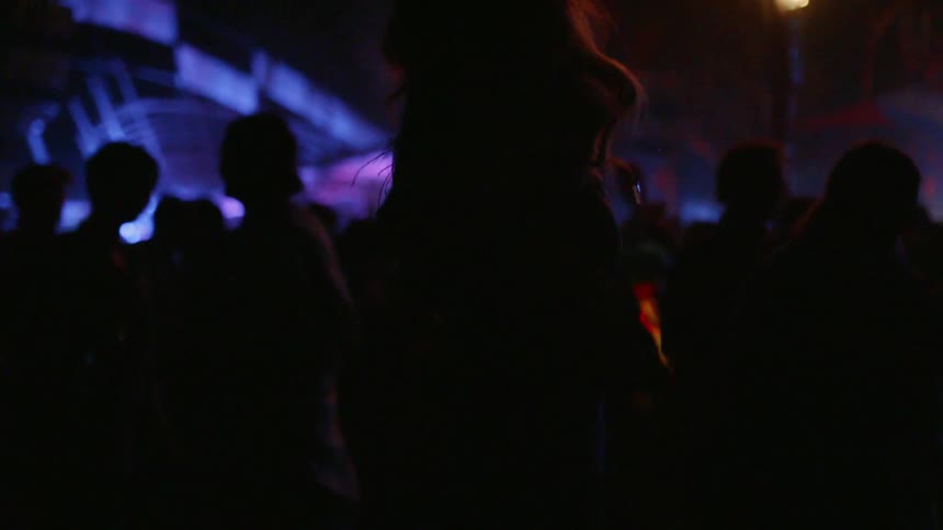Woman dancing in a nightclub filled with people