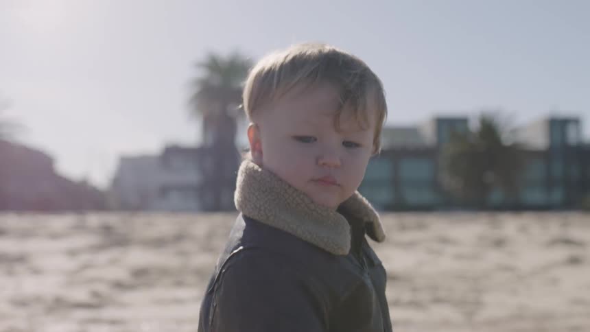 A child is walking along the field