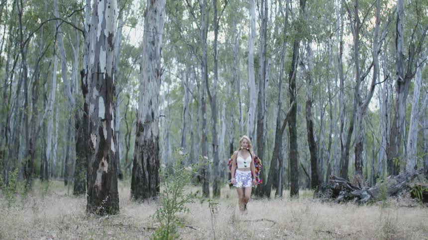 A woman walks through the wood