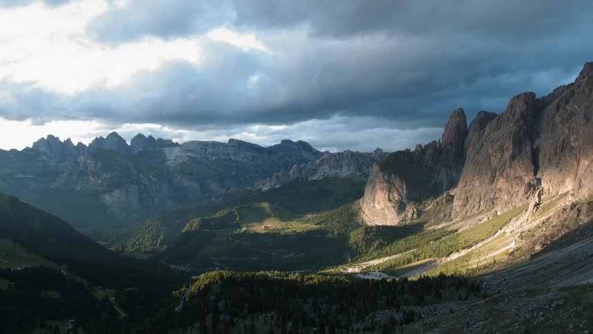 Dark clouds pass above the large canyon