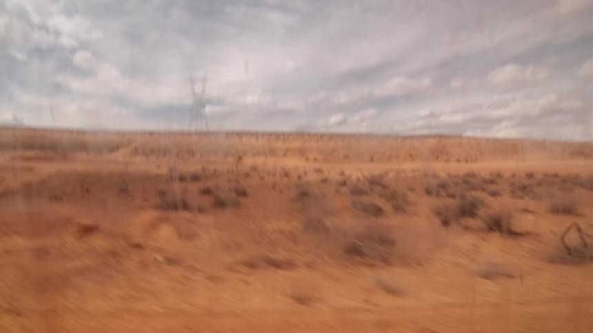 The desert ie empty with heavy clouds