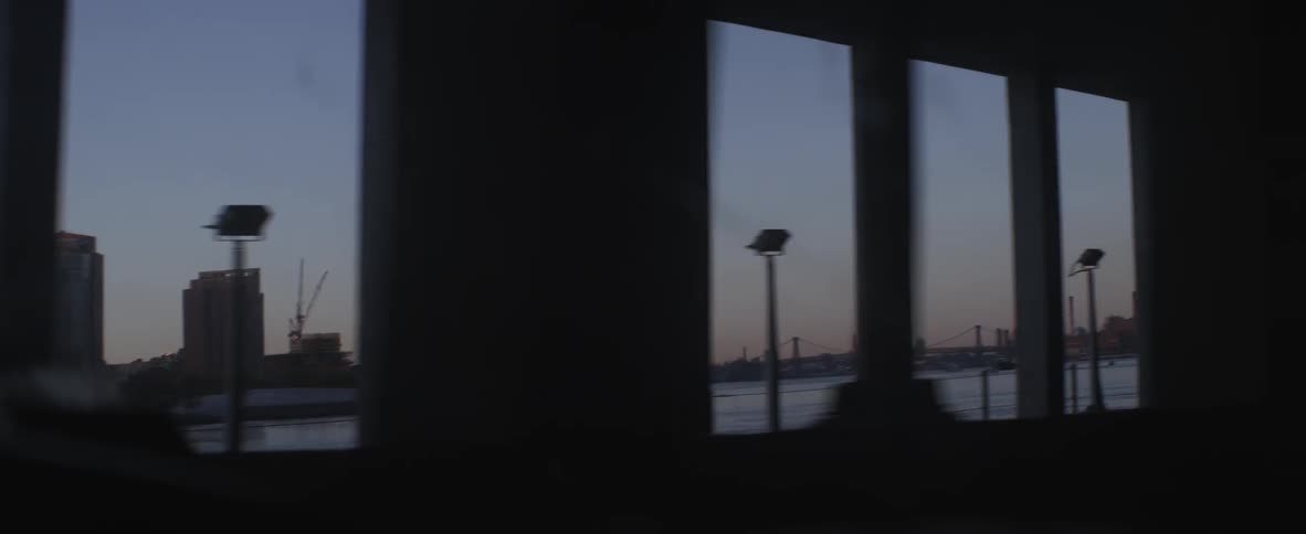 Driving across a bridge looking out the window at dusk