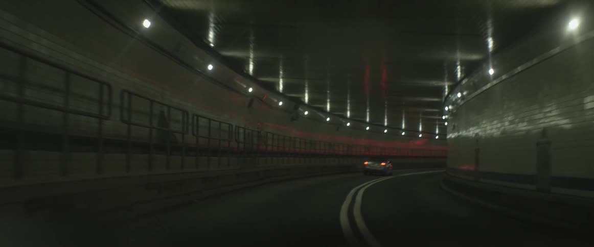 A car is driving through a tunnel