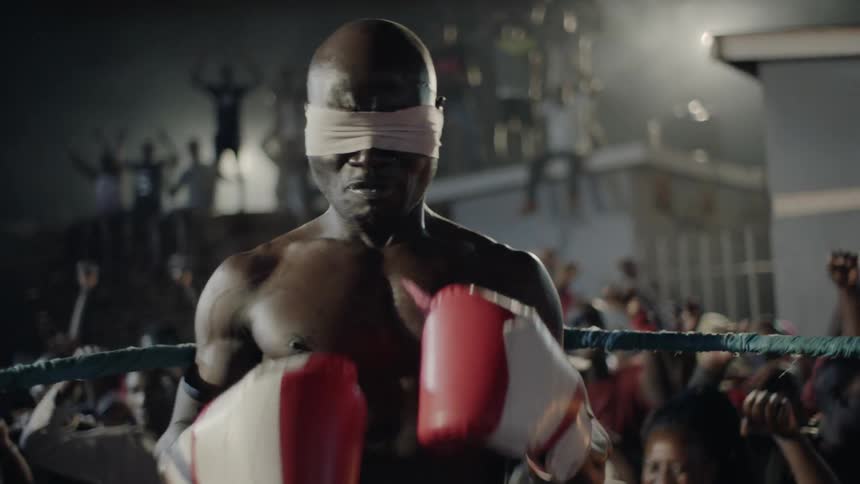 A man boxes at an outdoor boxing match