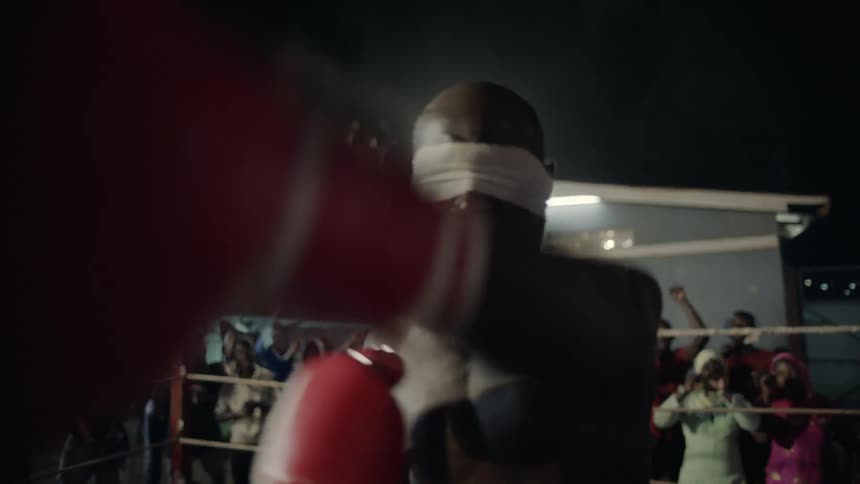 A man boxes at an outdoor boxing match