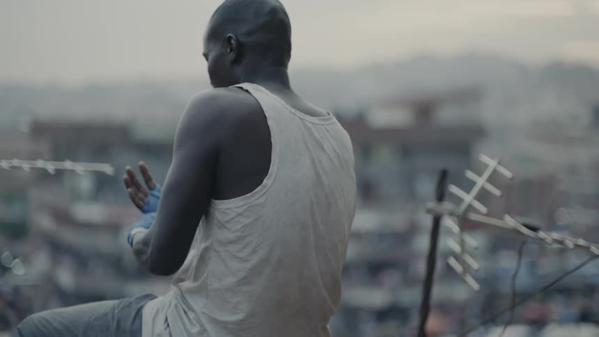 Man wraps his hand with athletic tape on a city rooftop