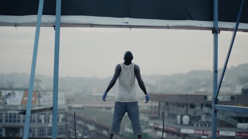 A man stands on a building rooftop