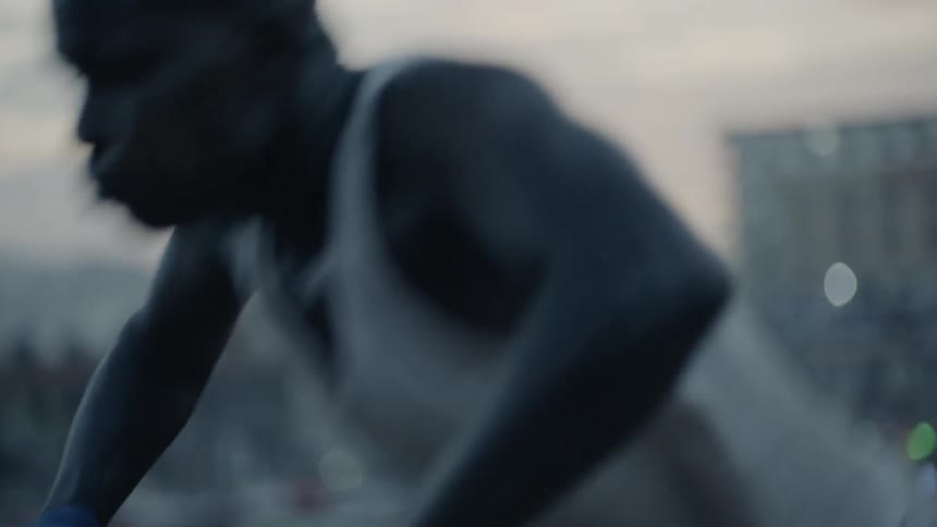 Man does push ups in a city at sunset