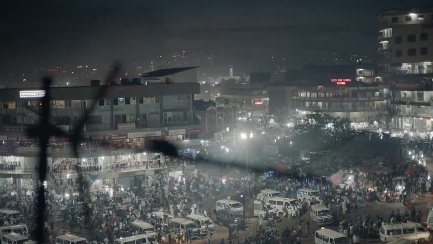 City streets crowded with people and vehicles at night