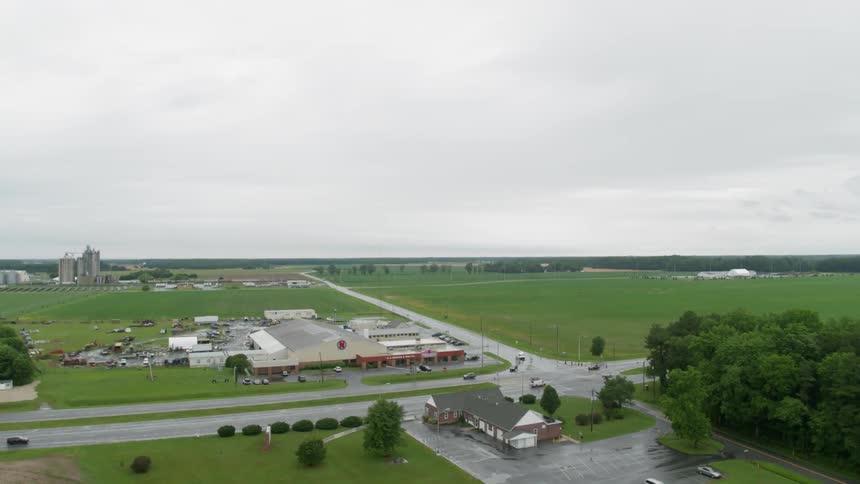 Vehicles drive down a road on flat plains
