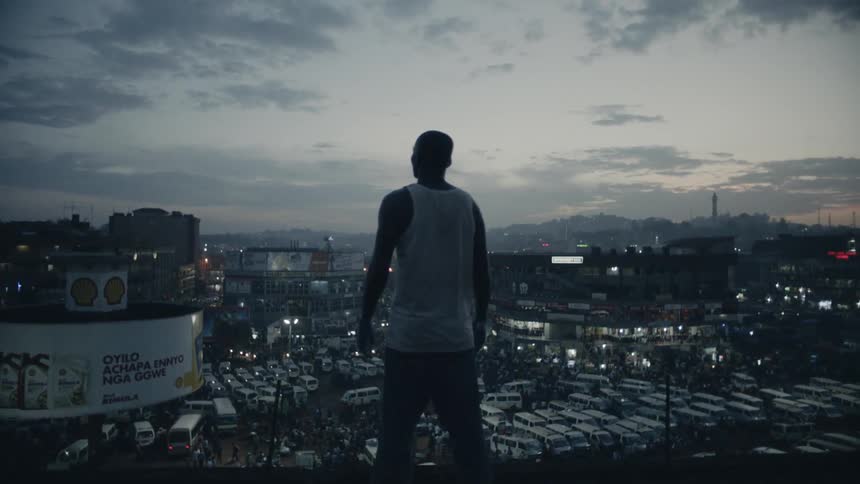 Man standing on rooftop viewing a cityscape