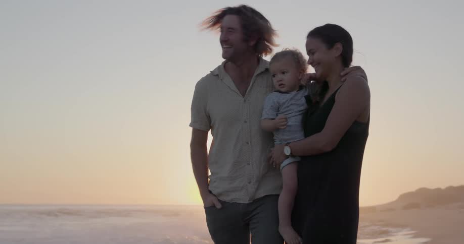 Couple and child standing on beach