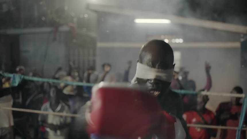 A man boxes at an outdoor boxing match