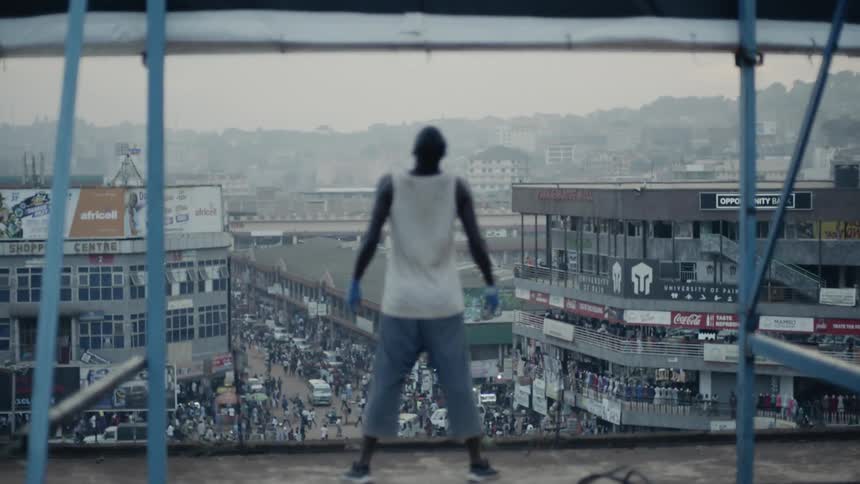 A man stands on a building rooftop
