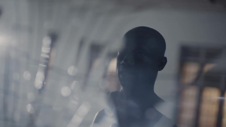Man's face is reflected in a shattered mirror