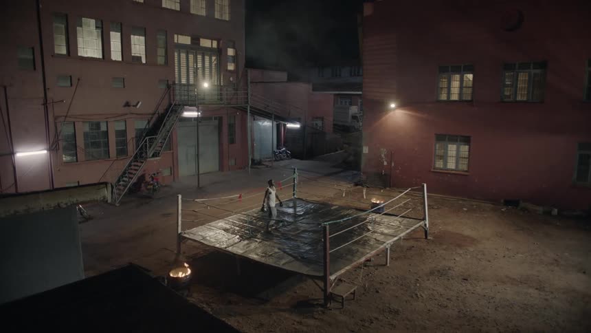 Man boxes alone in an outdoor boxing ring