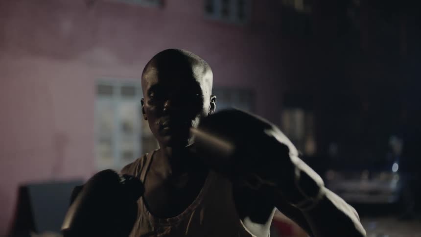 A boxer punches the air