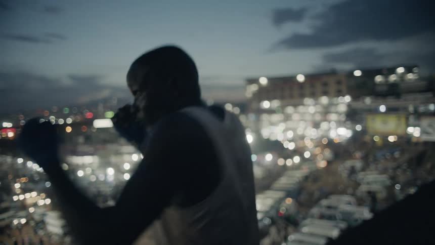 Man on rooftop practices boxing