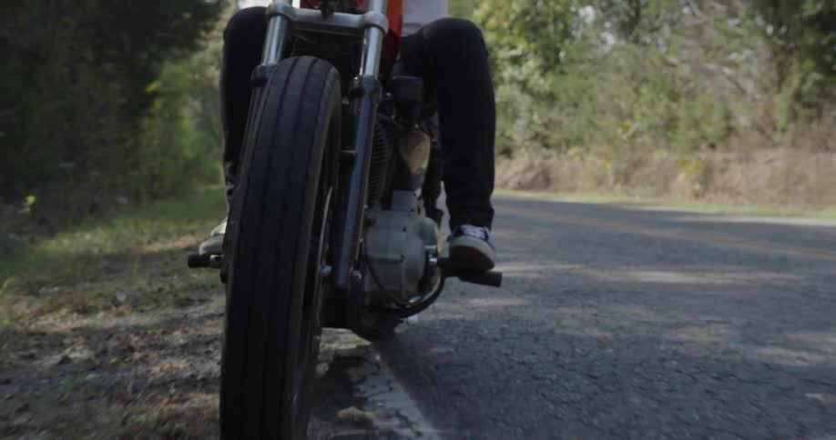 A motorcyclist pulls over on a rural road