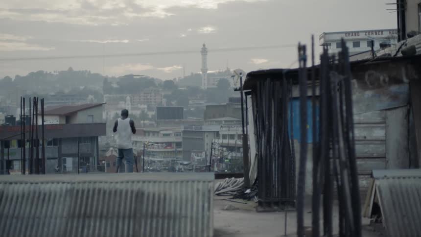 A boxer punches the air on a building rooftop