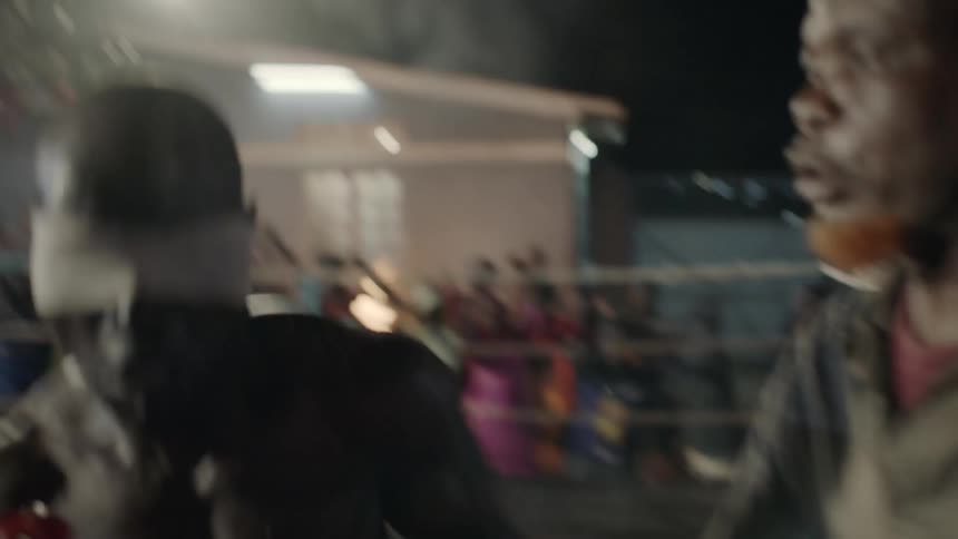 A man boxes at an outdoor boxing match