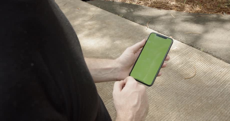 A man scrolls on a smartphone